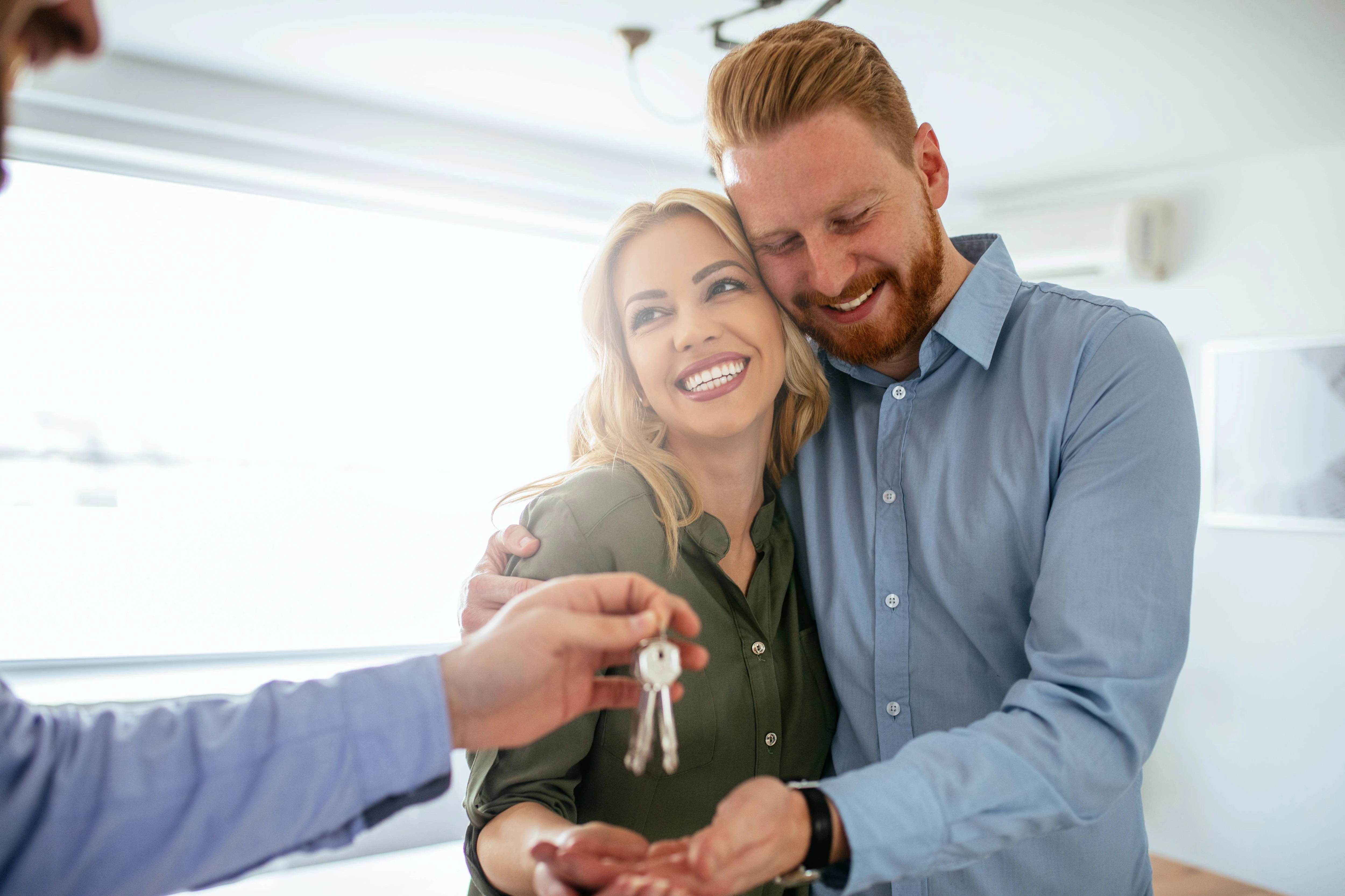 A happy couple receive the key for their new home.