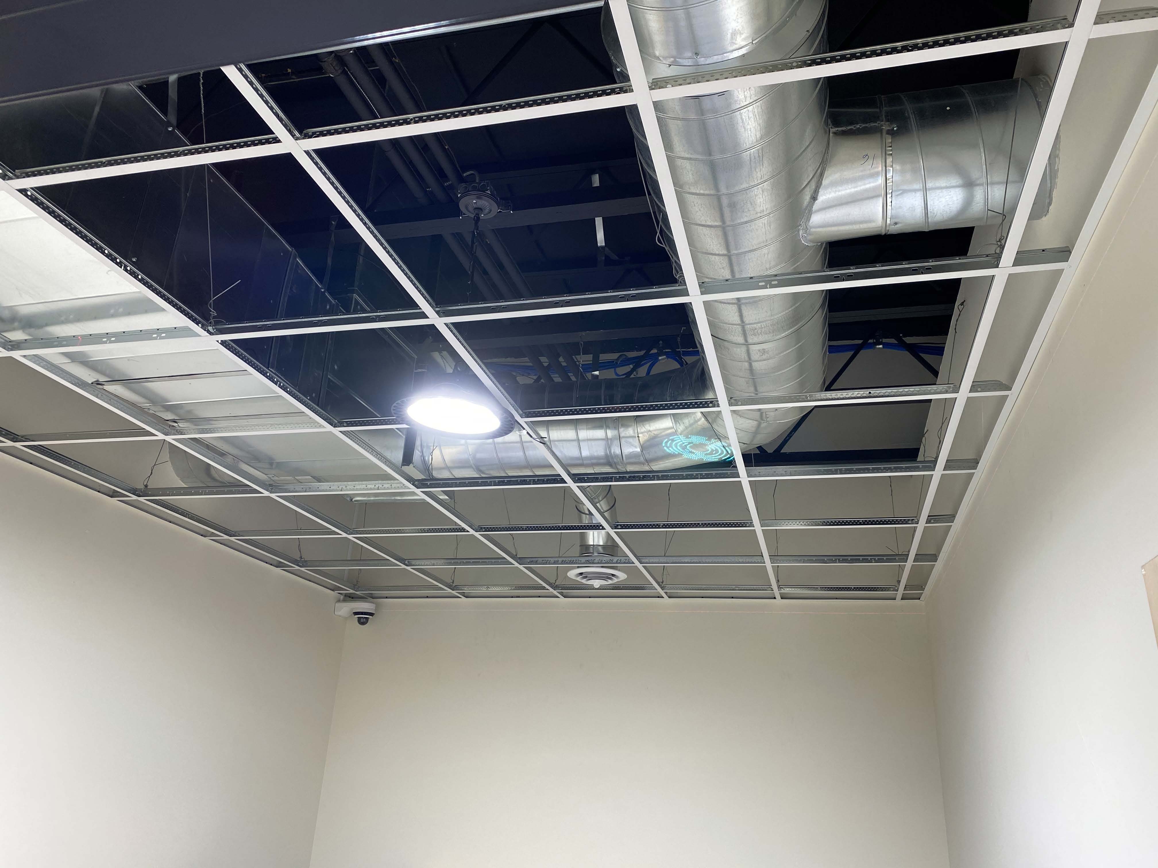 Modern commercial office with acoustic ceiling tile installation