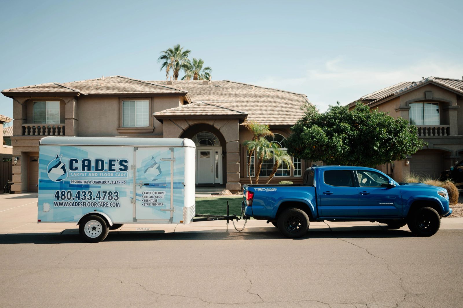 Cade's Carpet & Floor Care truck and trailer at a customer's home