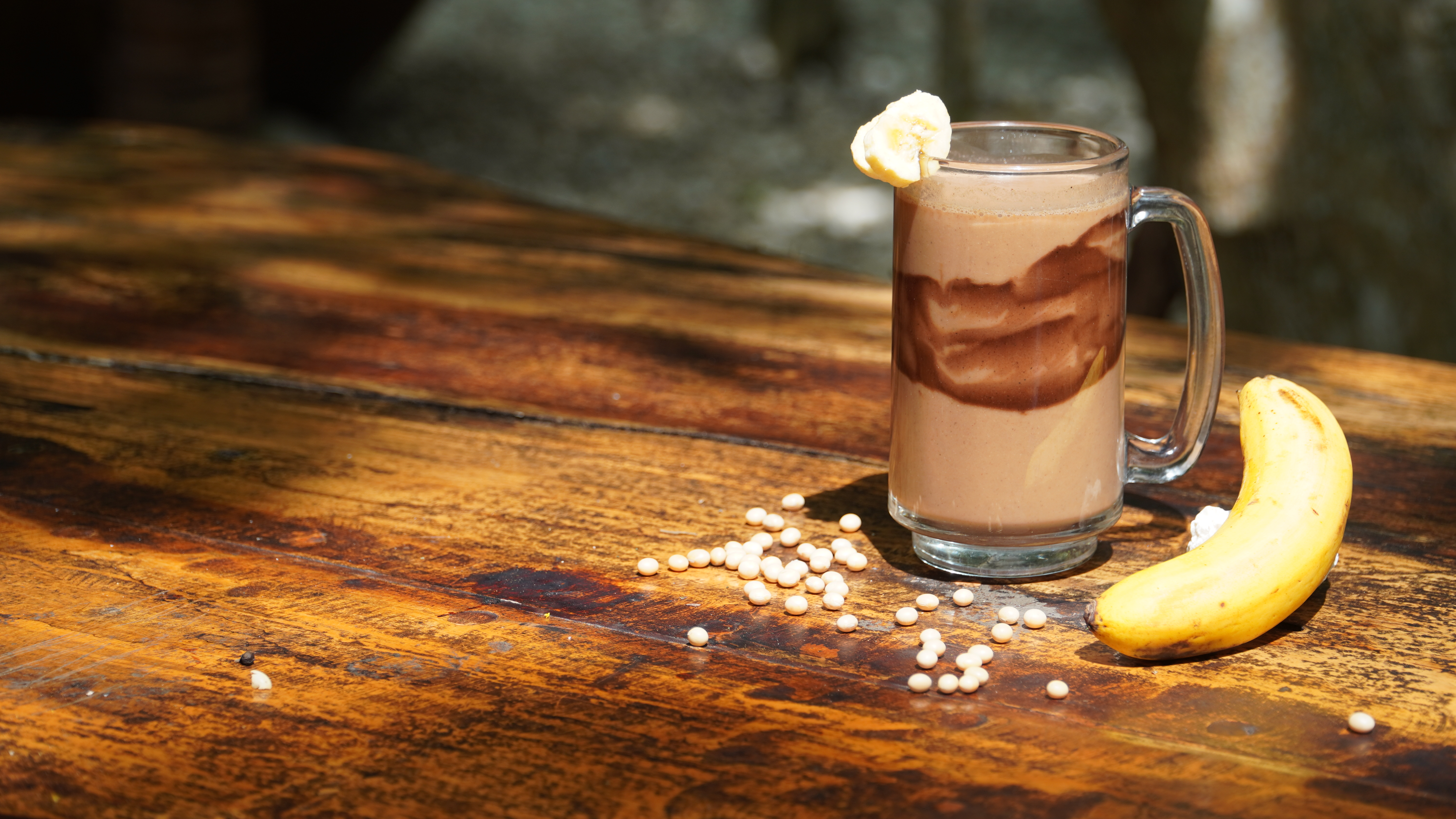 The Kinaiya Recovery Shake on a wooden table, with a banana