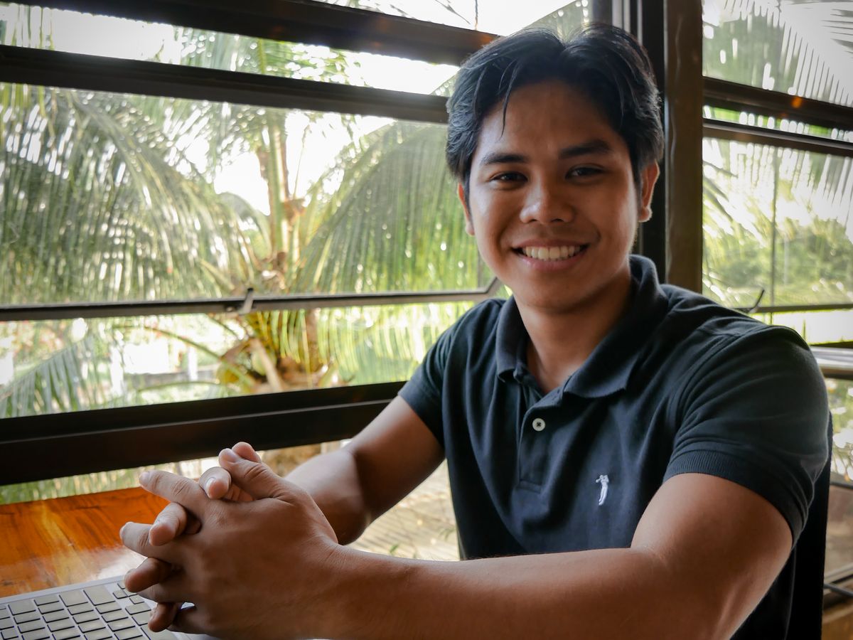 One of our health coaches at a table by the window at Bohol Coco Farm
