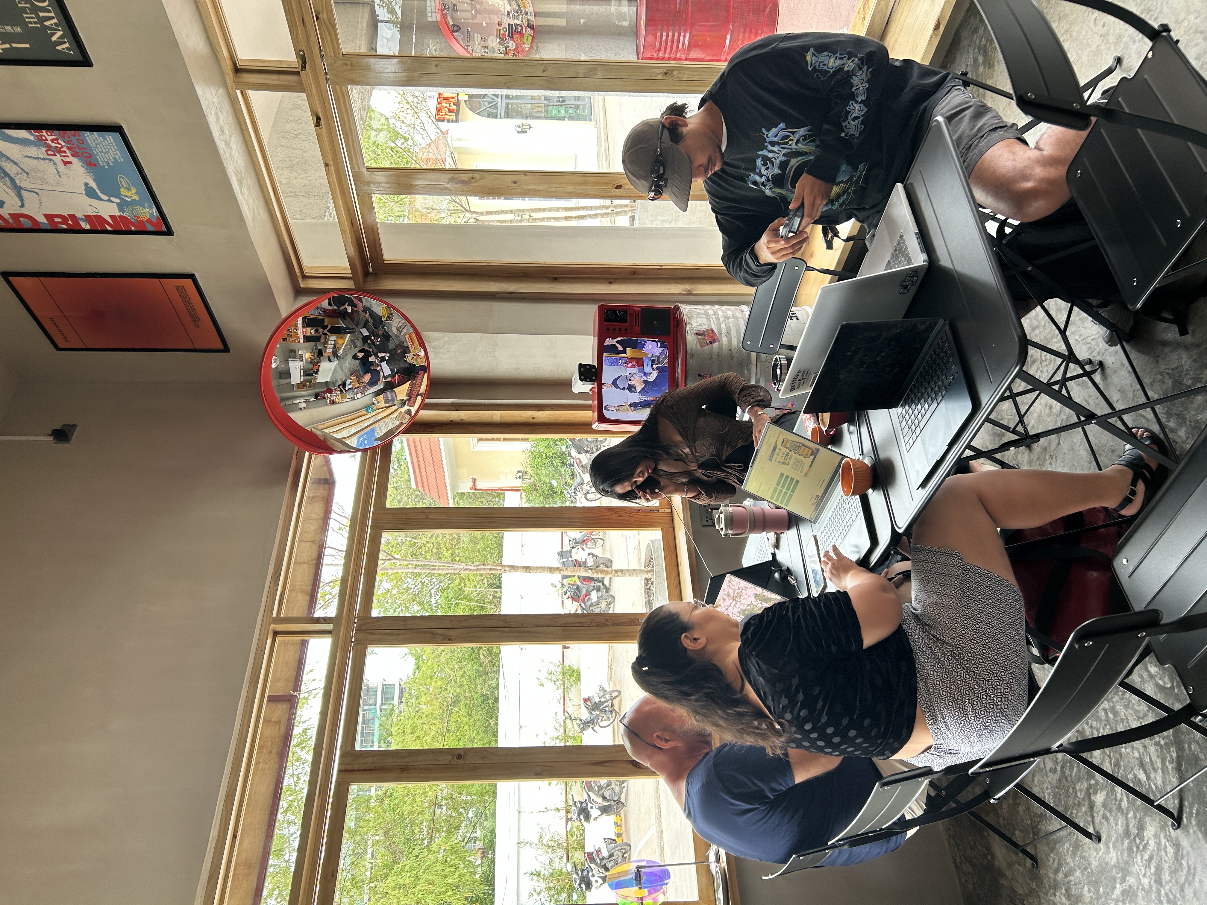 People working on laptops around a shared table