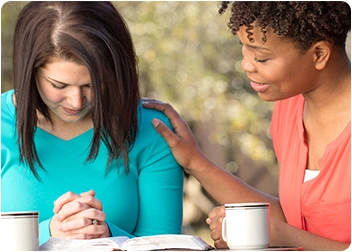 Woman comforting another woman