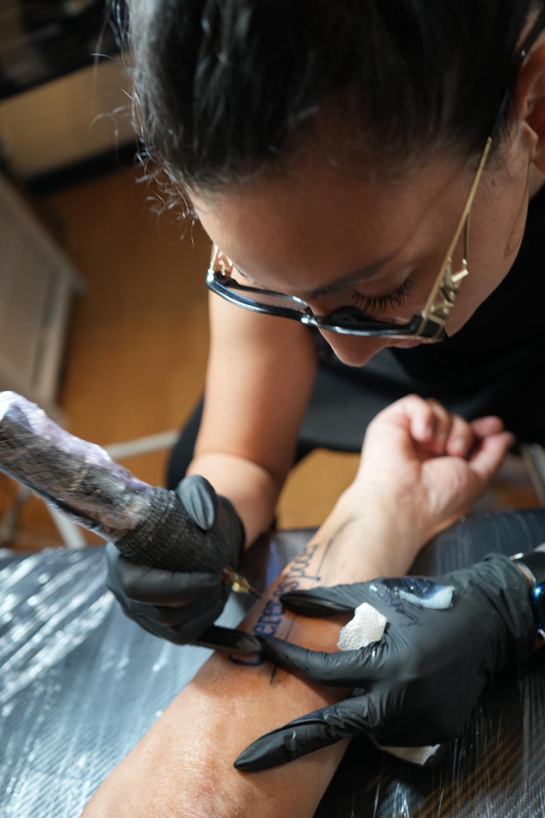 Tefi tatuando en sesión