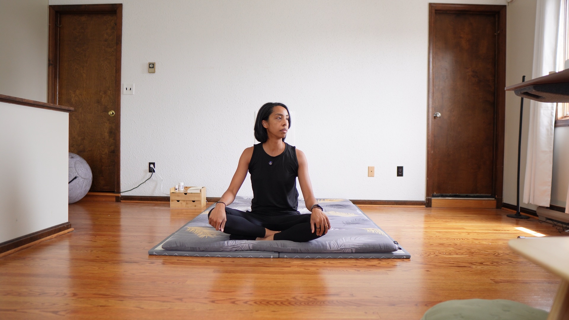 Natasha sitting on a Zonli floor futon
