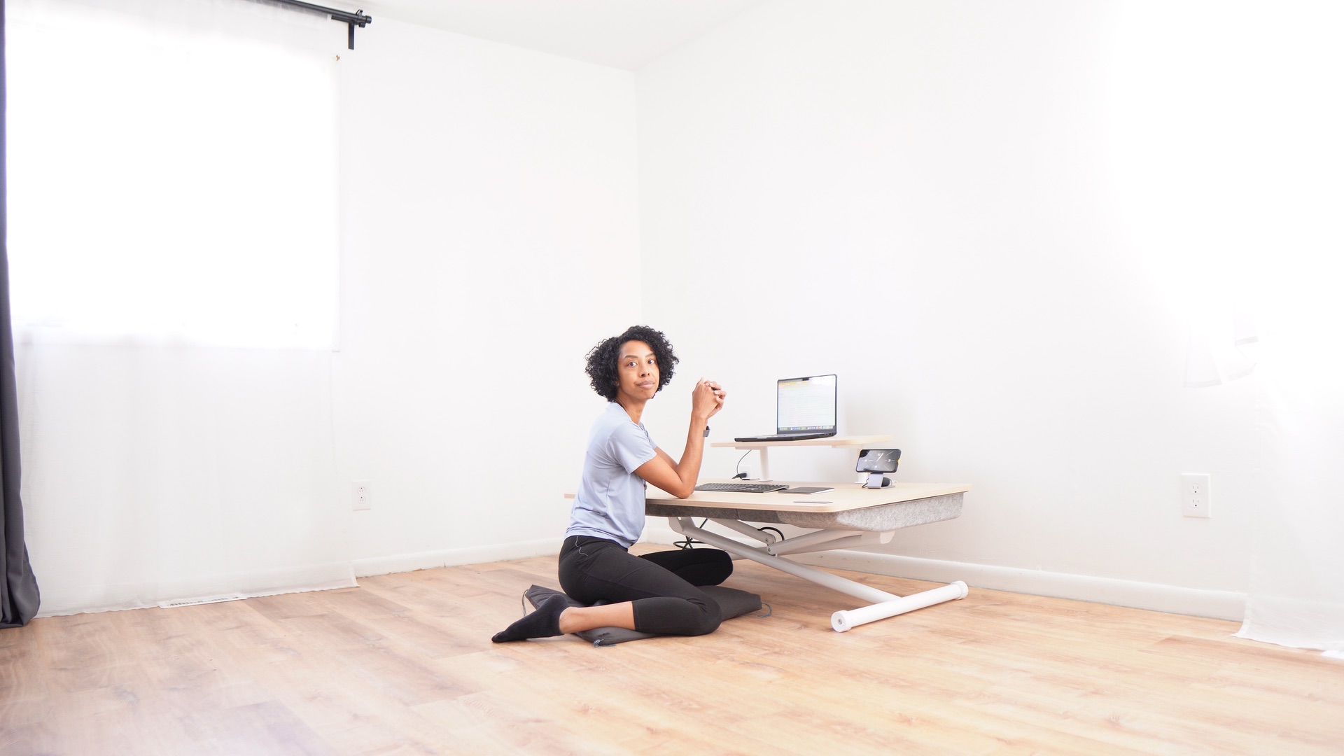 Natasha working at a Marinamantra floor-to-standing desk