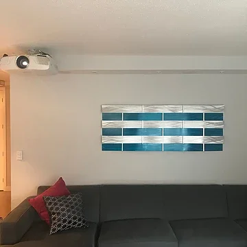 Projection screen replacing a wall-mounted TV in a Manhattan living room