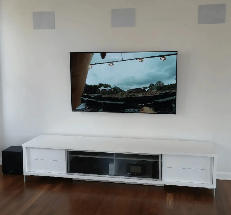 65 inch OLED with Paradigm surround sound speakers installed in a NYC apartment