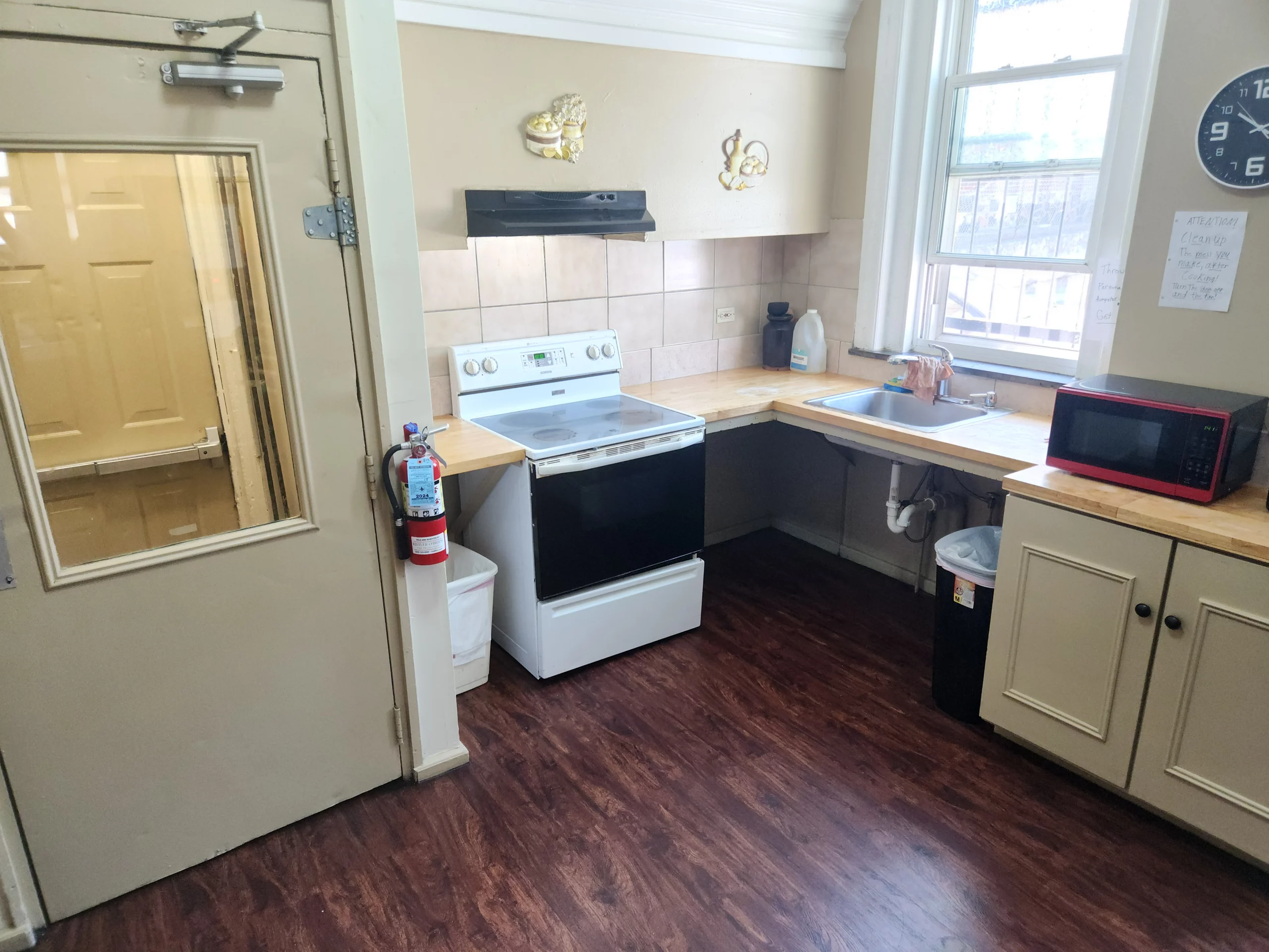 Shared kitchen with cooking stove and meal prep space