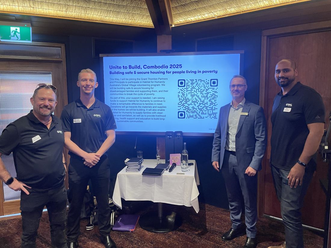 Team presenting at a Habitat for Humanity charity fundraiser