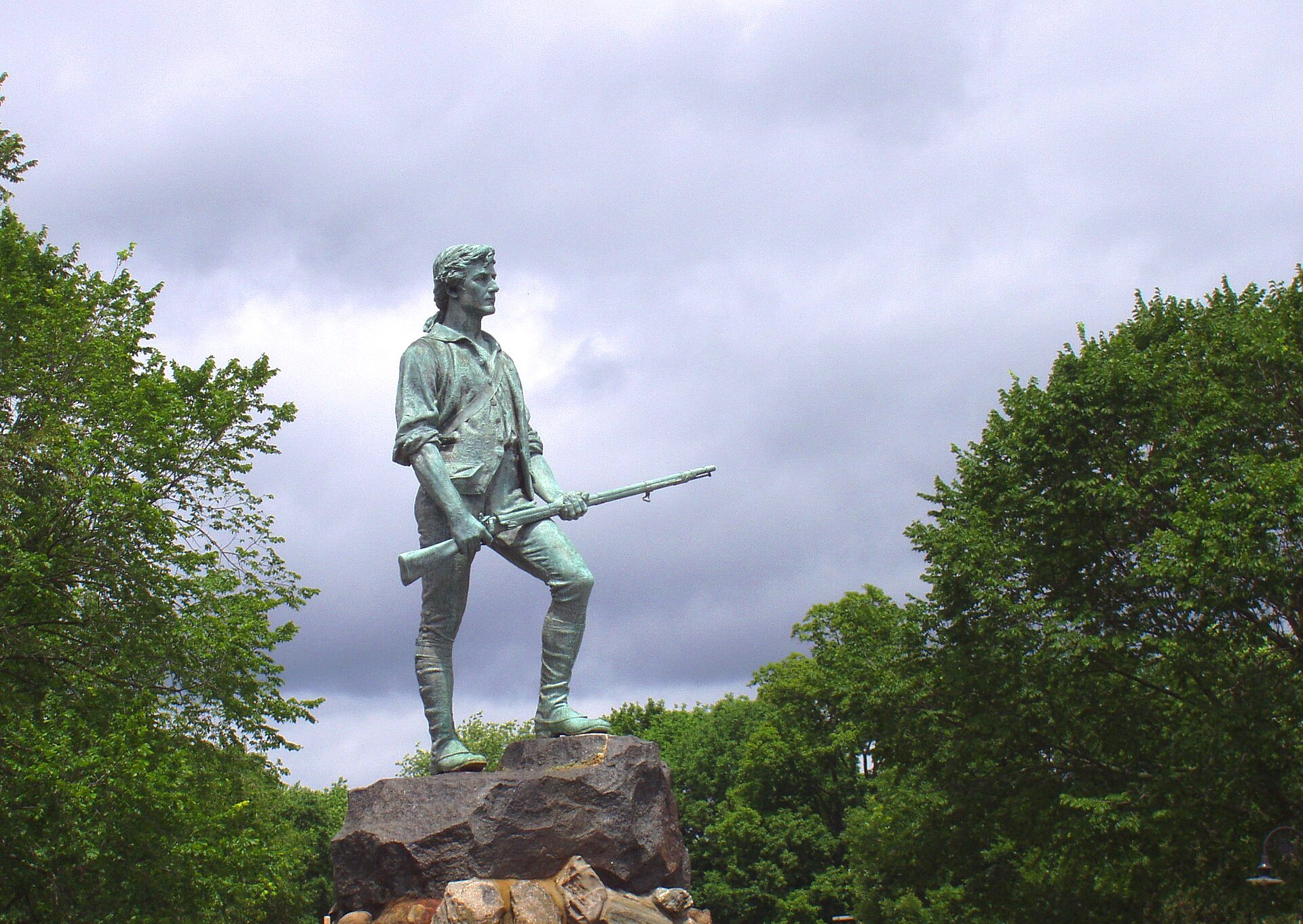 Historic Lexington Battle Green with Minuteman Statue and colonial-era buildings along Massachusetts Avenue in Lexington, Massachusetts