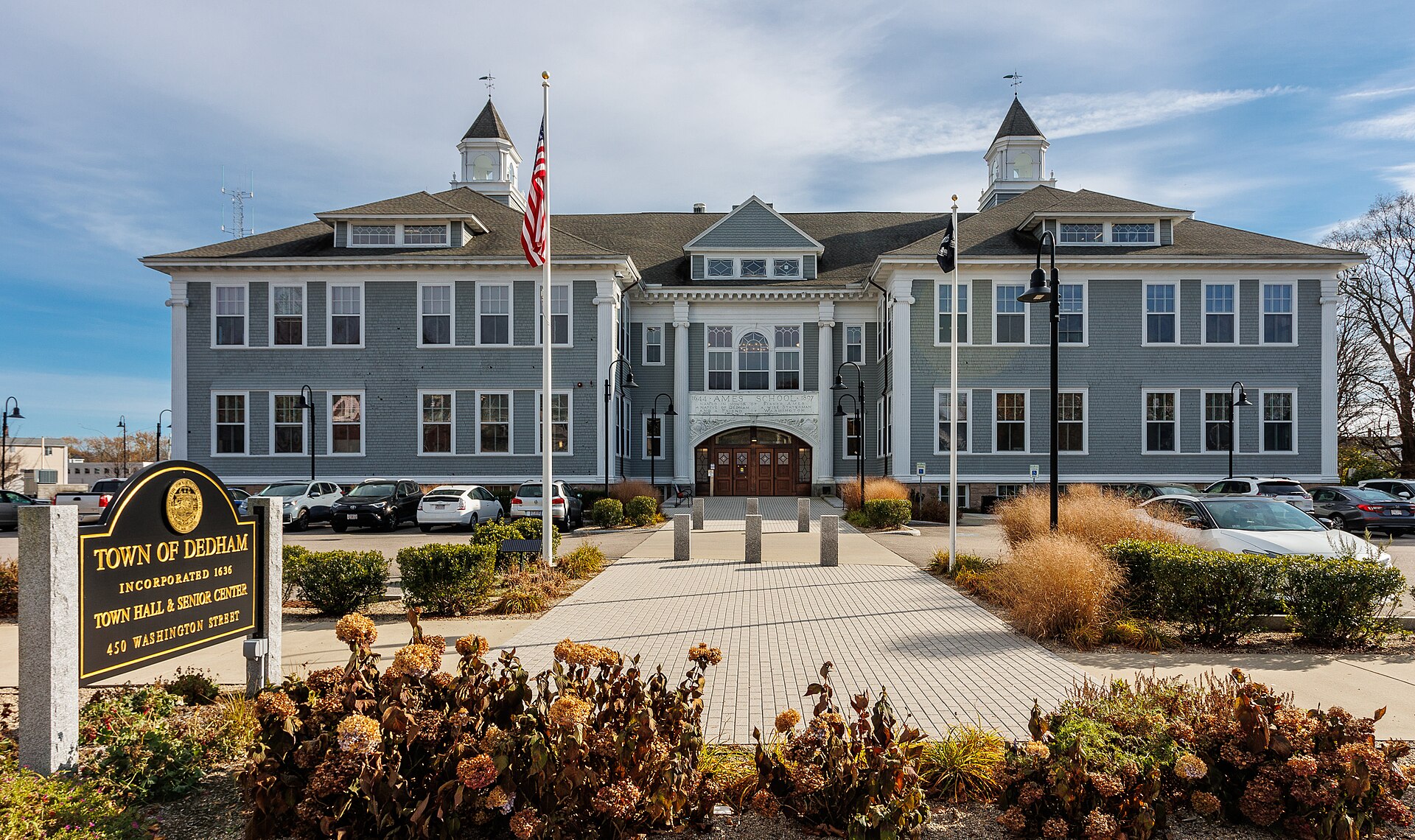 Historic Dedham Square streetscape with tree-lined sidewalks and colonial-era architecture in Dedham, Massachusetts