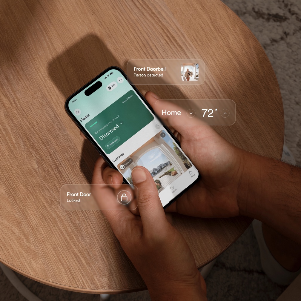 The Vivint Smart Home app running on a phone, showing live doorbell detection, thermostat control, and a locked front door