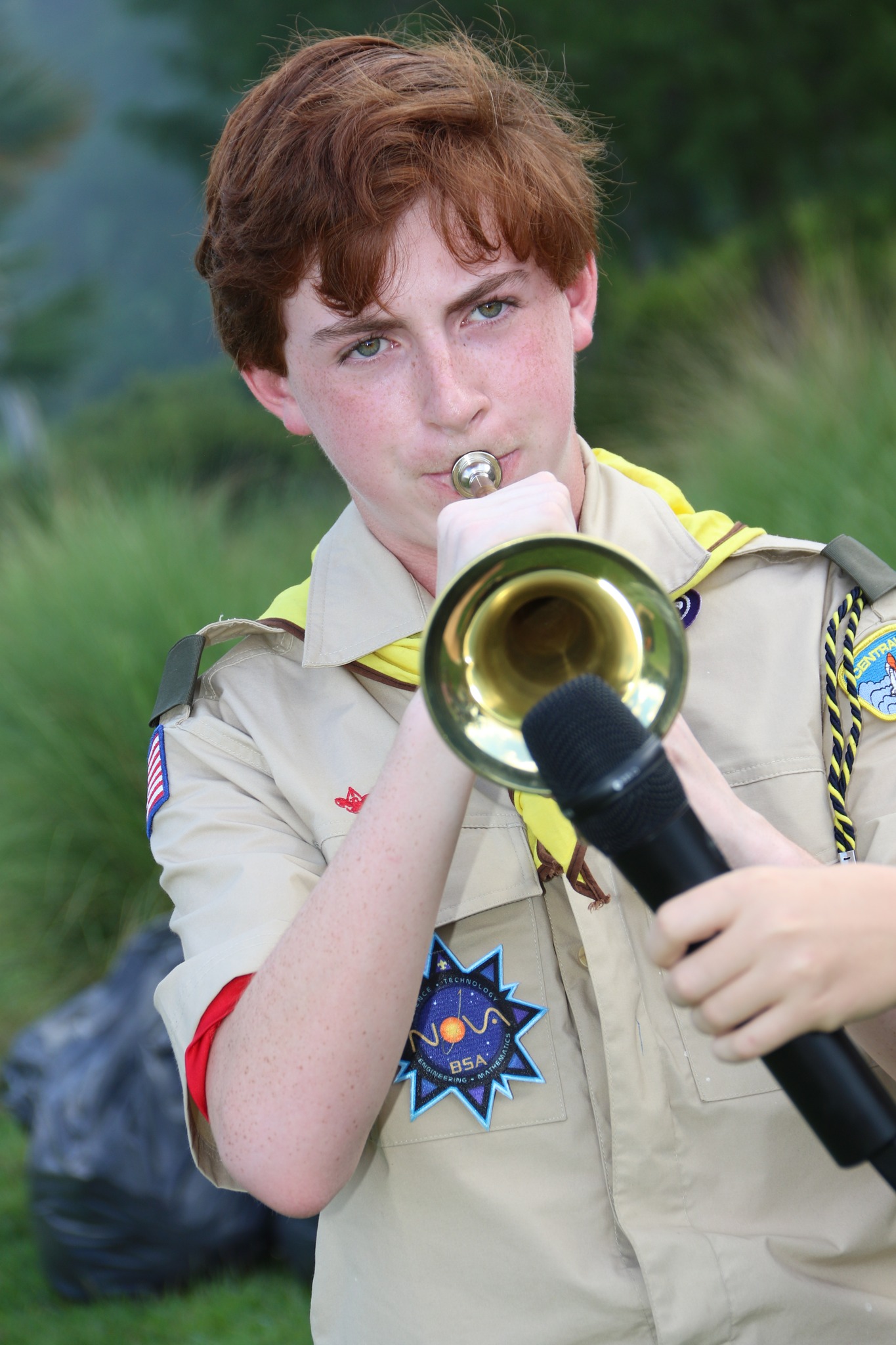 A Scout playing bugle at a Scouting event