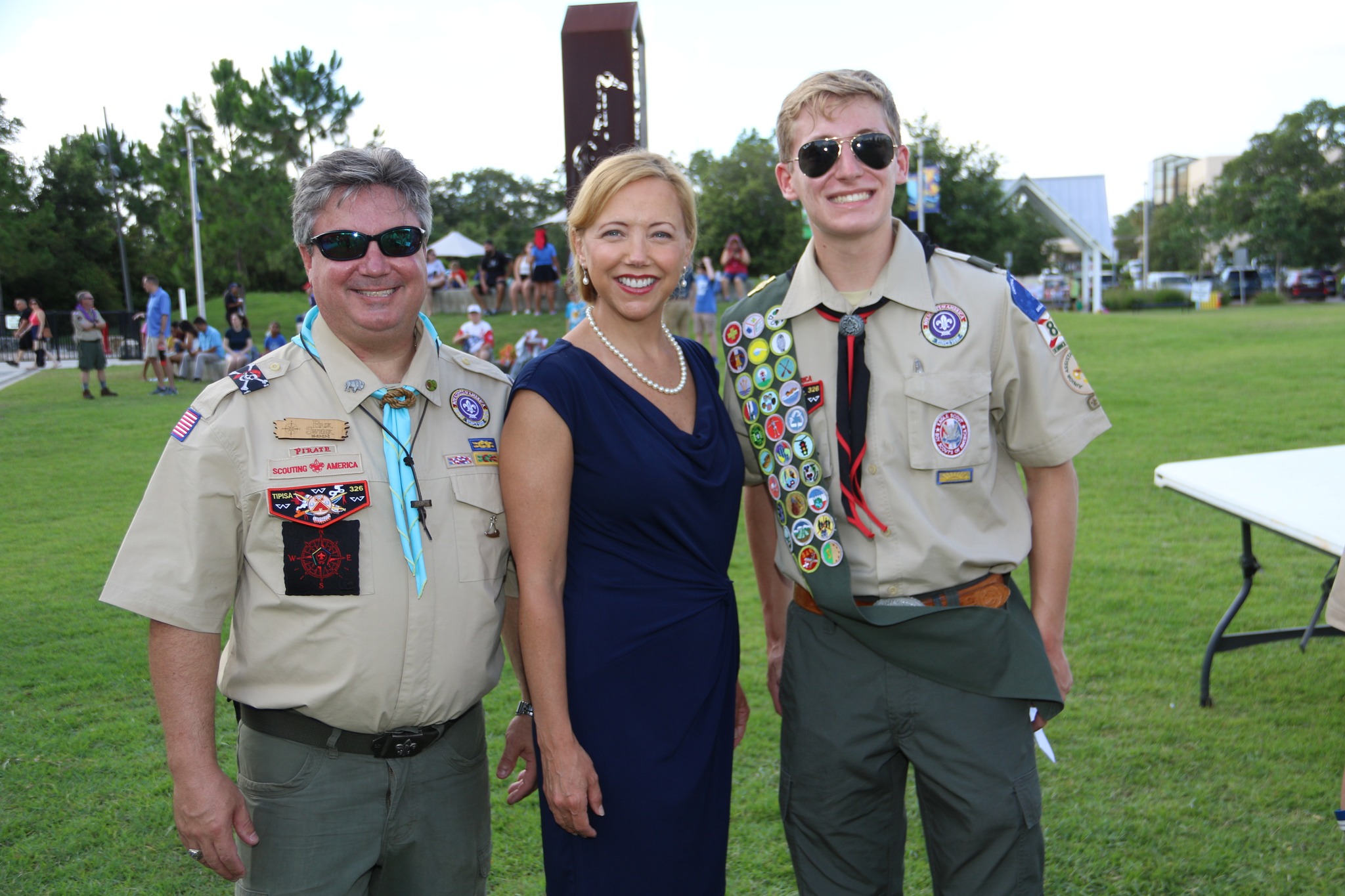 Family in Scout uniforms outdoors