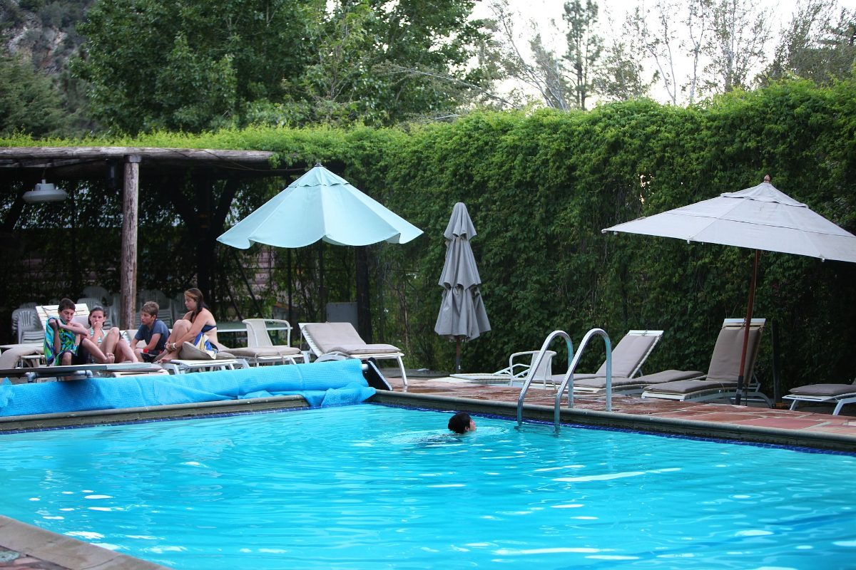 The Lodge pool with umbrellas and lounge chairs