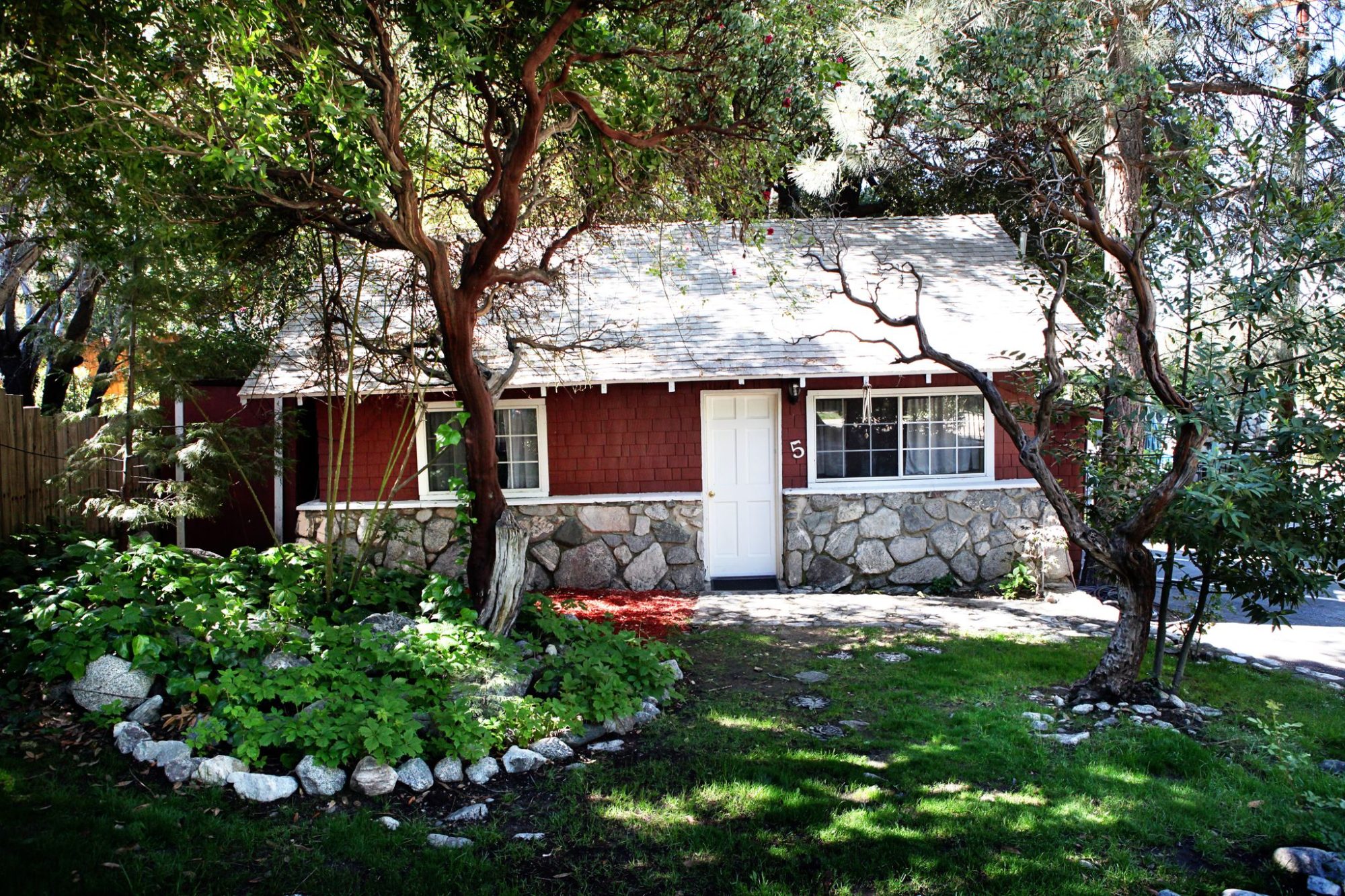 A red Lodge cabin among gardens and pines