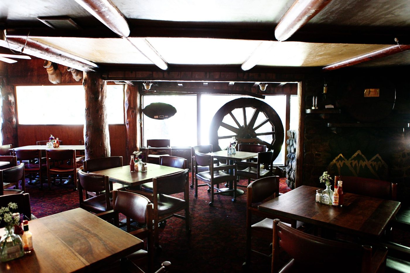 The Lodge dining room with wagon-wheel decor and the bar