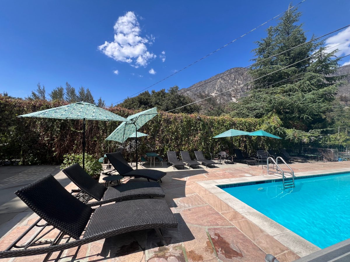 The pool and lounge chairs with the mountain behind
