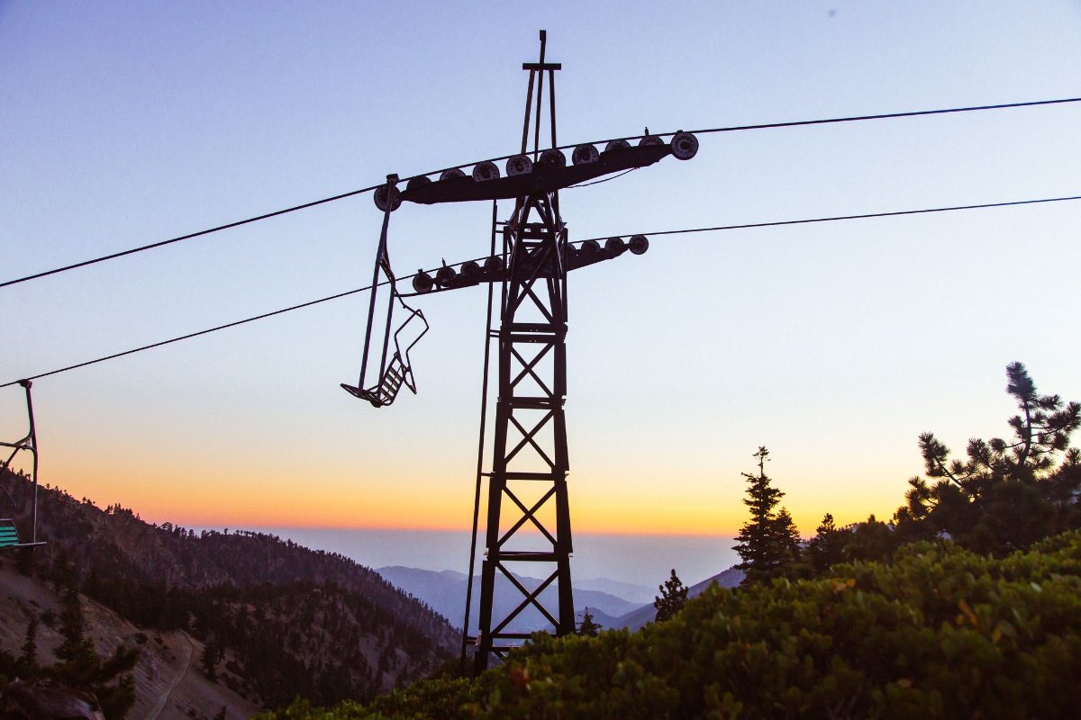 A lift tower and chair at sunset