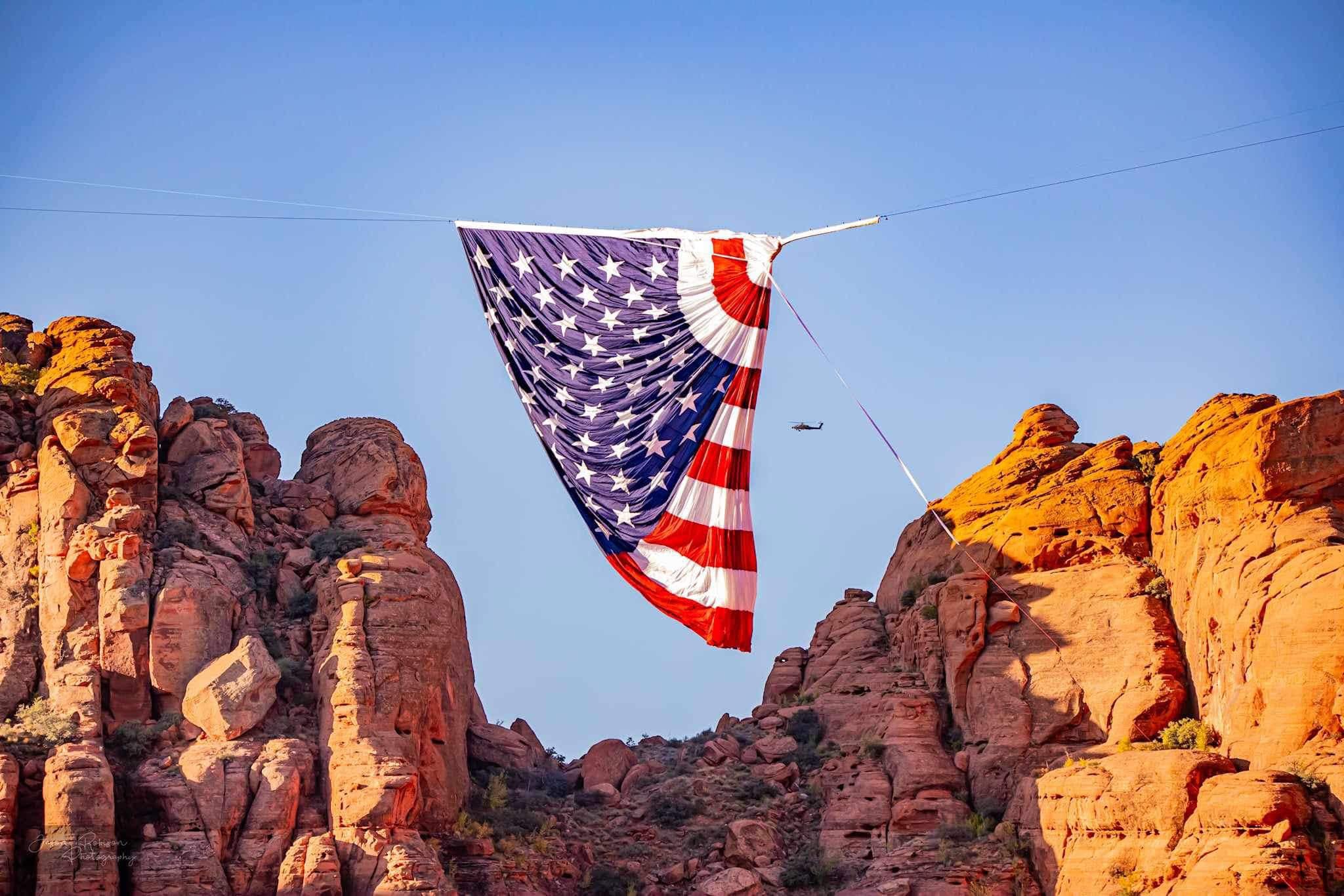 Sunlight through the flag above the red rock of Southern Utah
