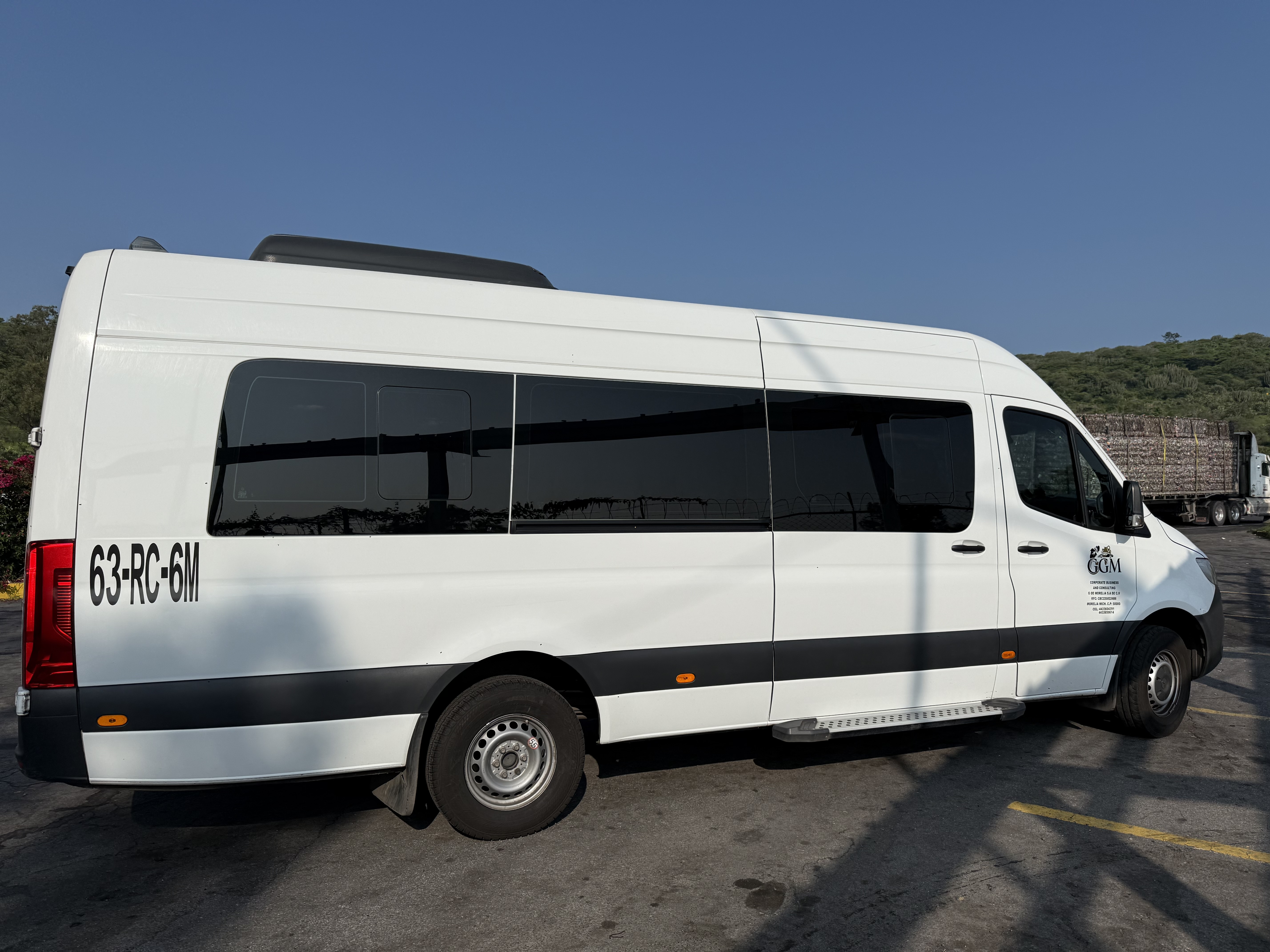 people riding in auto rickshaw near building