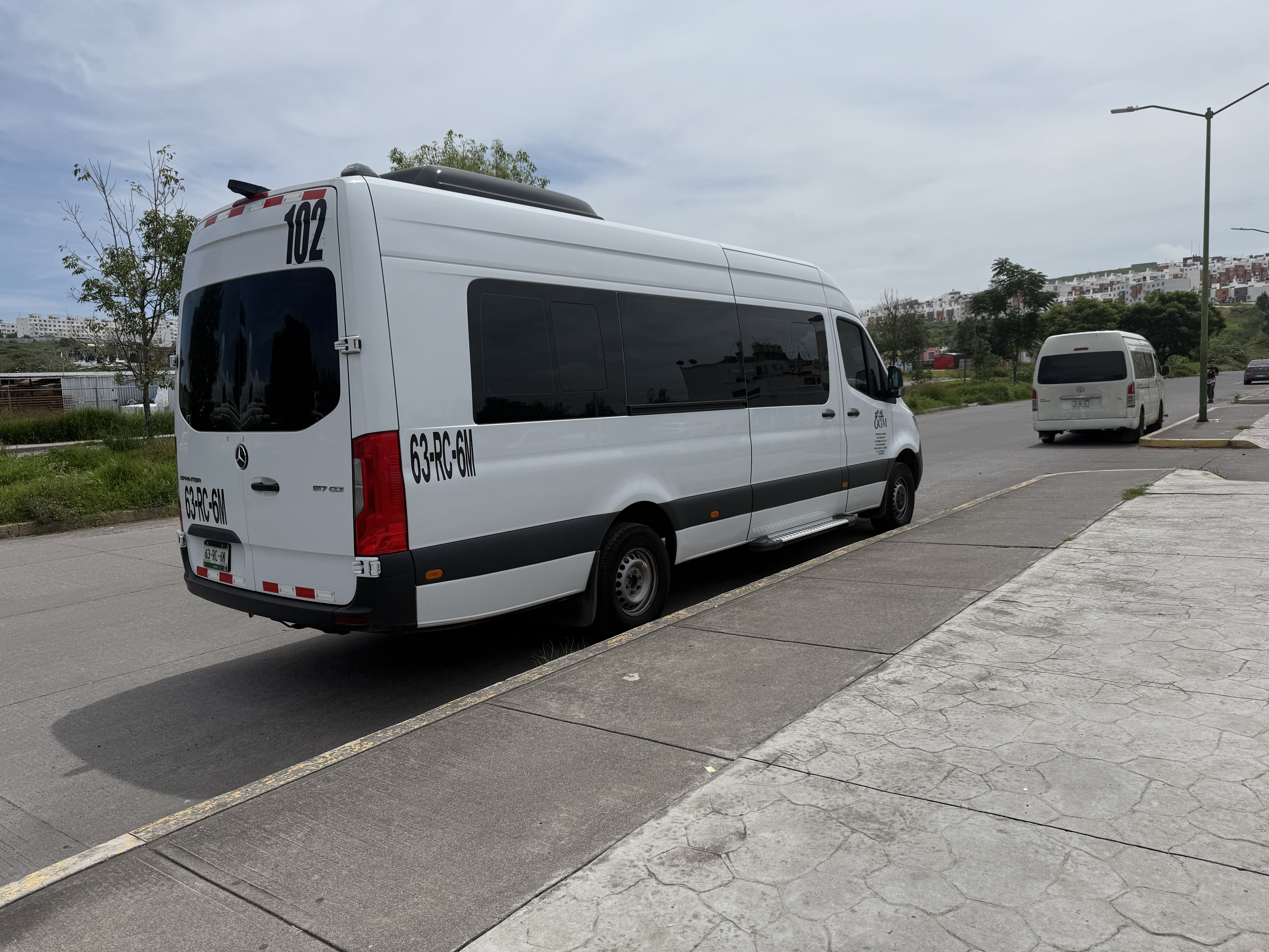 people riding in auto rickshaw near building