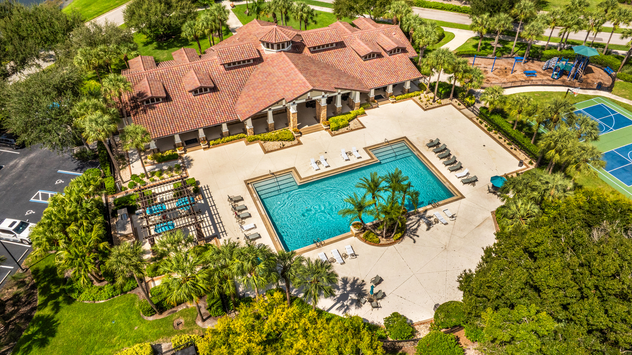 Aerial view of the Hampton Park at Gateway clubhouse, resort-style pool, pickleball and basketball courts in Fort Myers