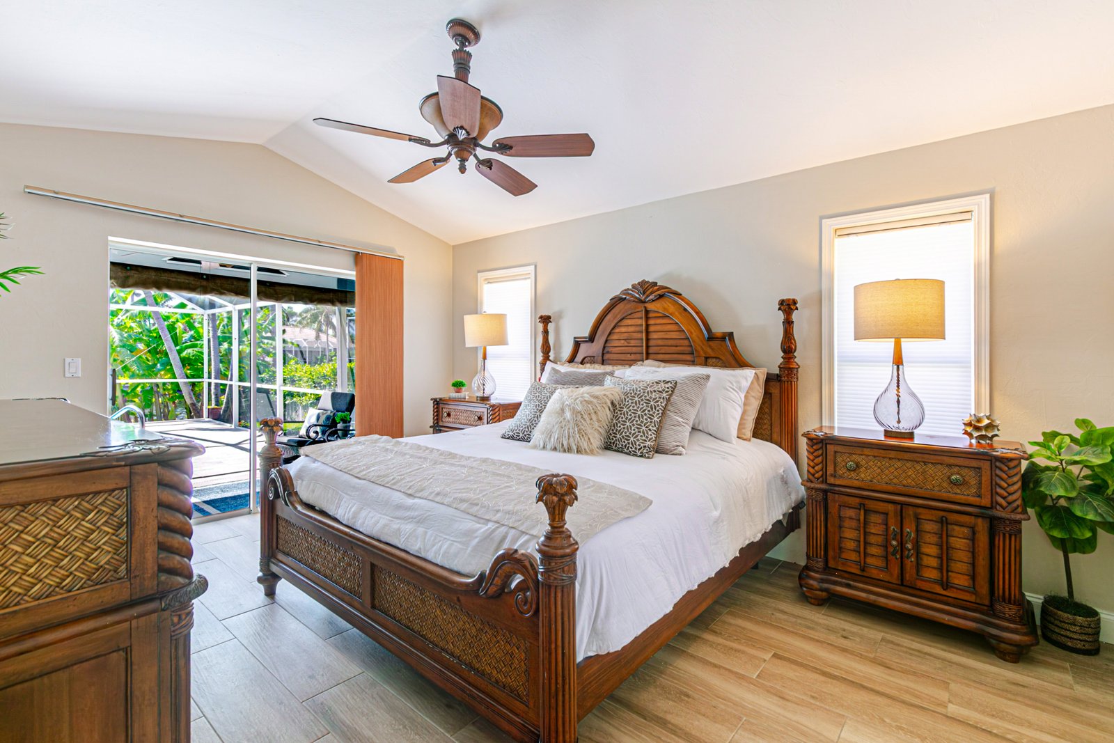 Primary bedroom with vaulted ceiling and sliders to the pool at 2828 SW 36th St, Cape Coral FL Primary bedroom with vaulted ceiling and sliders to the pool at 2828 SW 36th St, Cape Coral FL