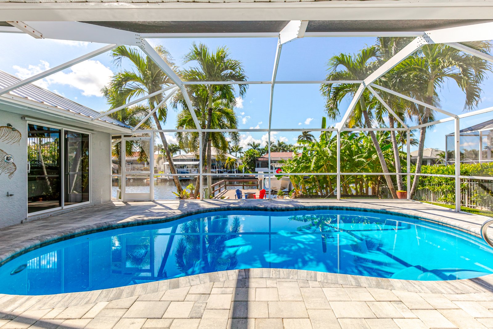Heated screened pool with paver deck overlooking the canal and dock at 2828 SW 36th St, Cape Coral FL Heated screened pool with paver deck overlooking the canal and dock at 2828 SW 36th St, Cape Coral FL