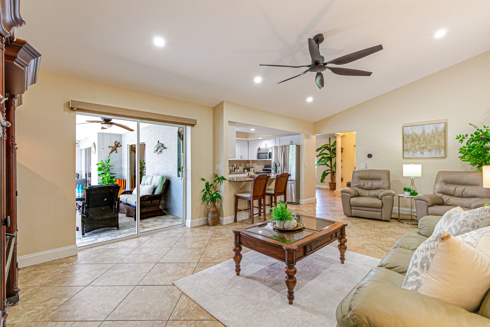 Family room with vaulted ceiling open to the kitchen and lanai at 2828 SW 36th St, Cape Coral FL Family room with vaulted ceiling open to the kitchen and lanai at 2828 SW 36th St, Cape Coral FL