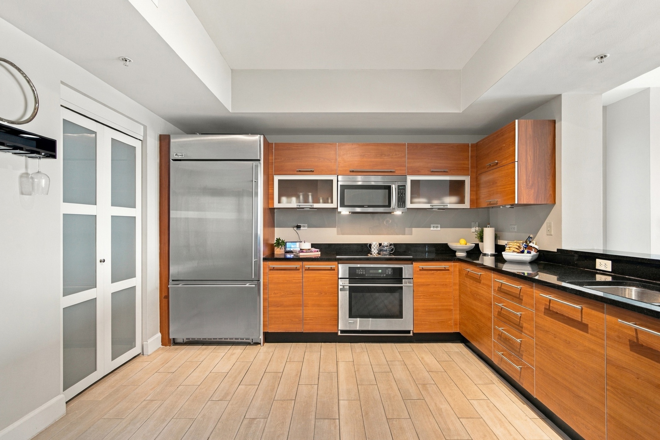 Kitchen with stainless appliances and granite counters at Oasis Grand #1401 in downtown Fort Myers