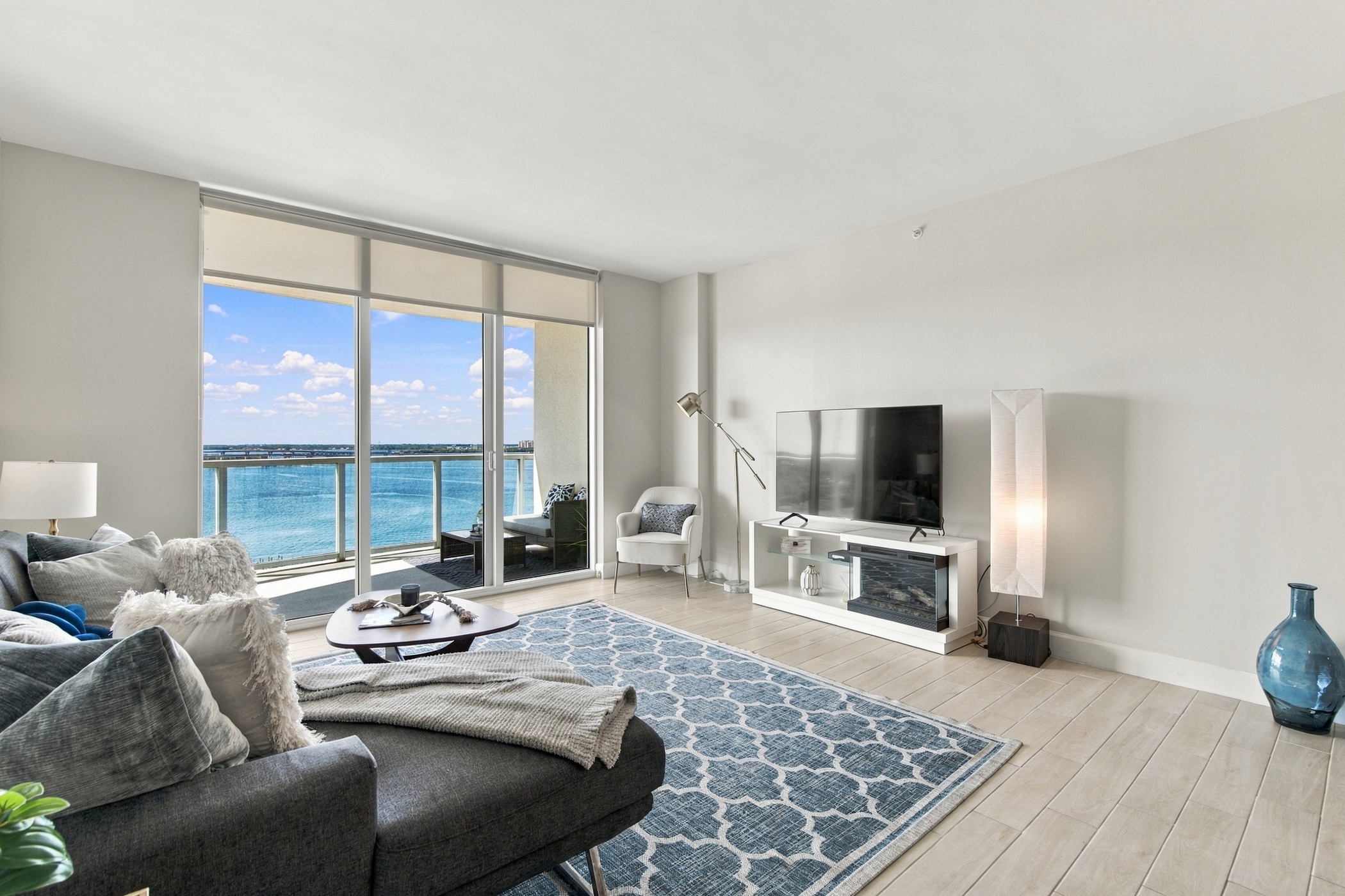 Great room with floor to ceiling windows and water view at 3000 Oasis Grand Blvd #1401, Fort Myers FL