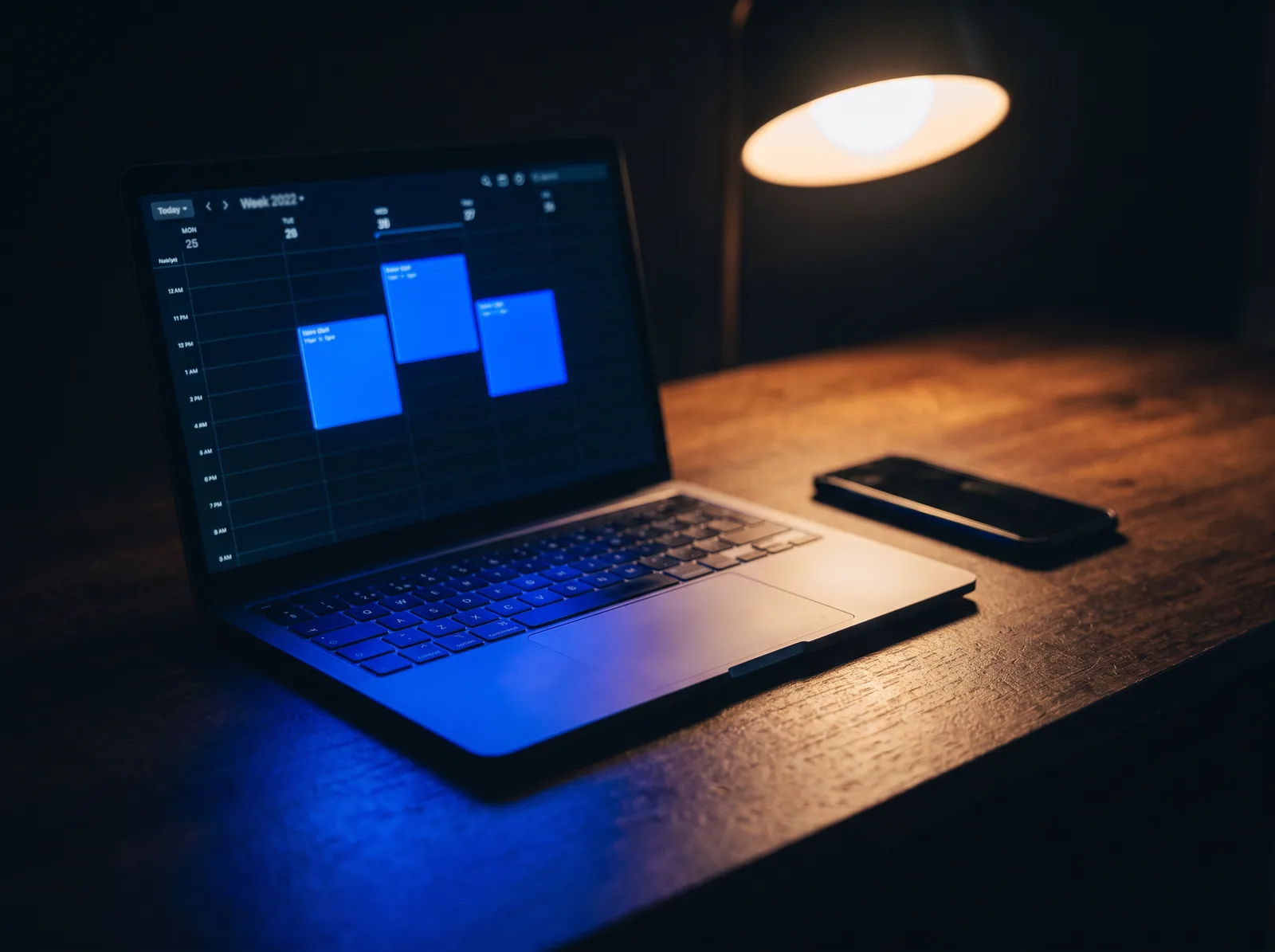 A laptop on a dark desk showing booked appointments