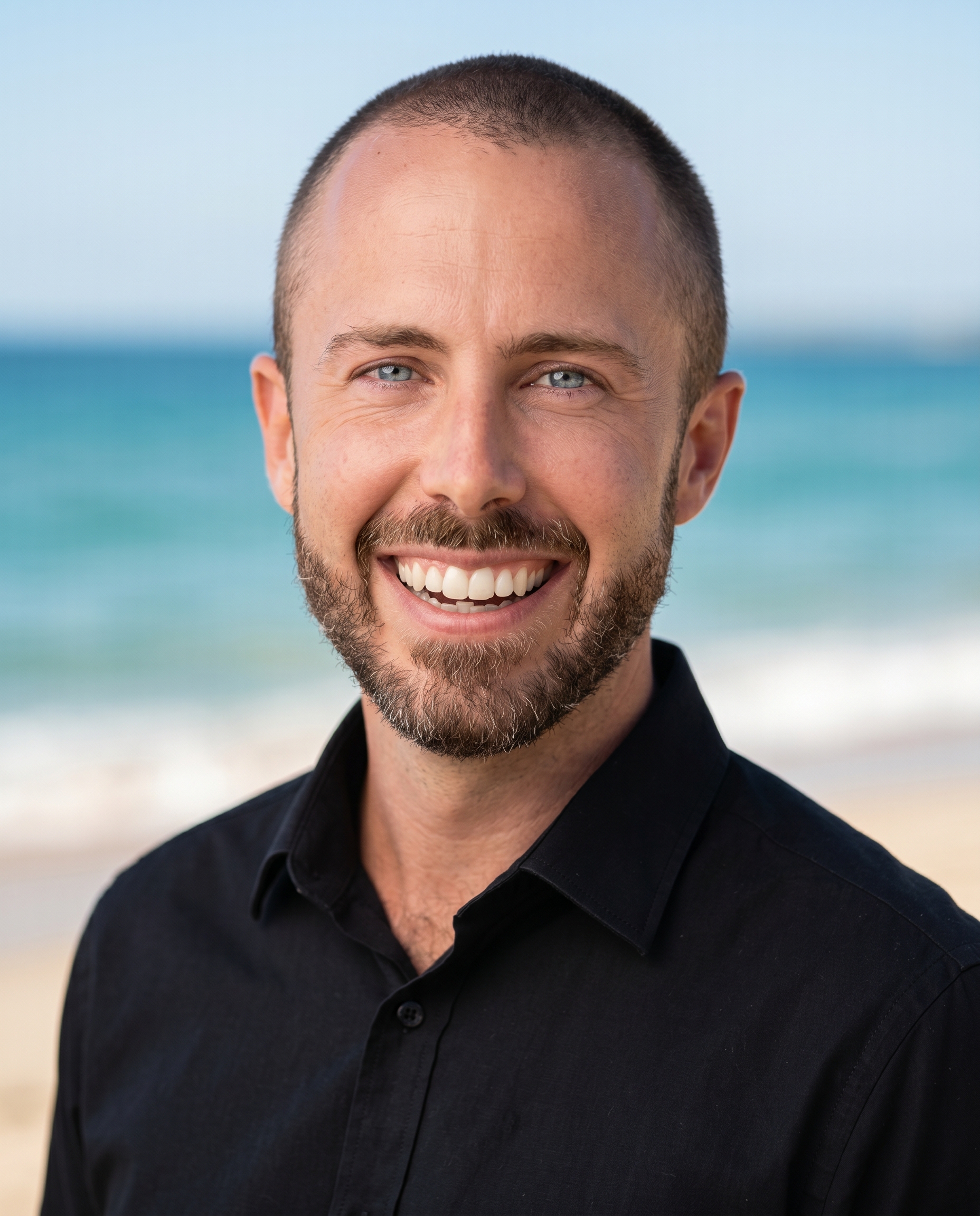 Peter Williams smiling by the ocean