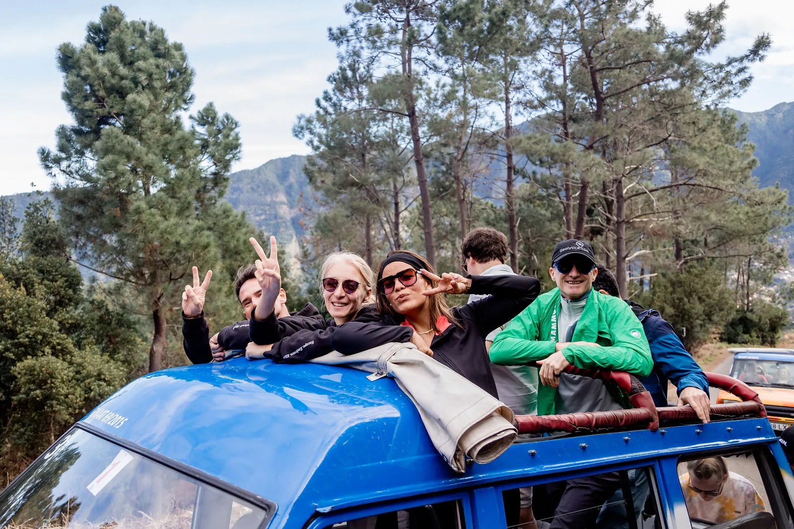 Founders waving from the roof of a jeep in Madeira's mountains