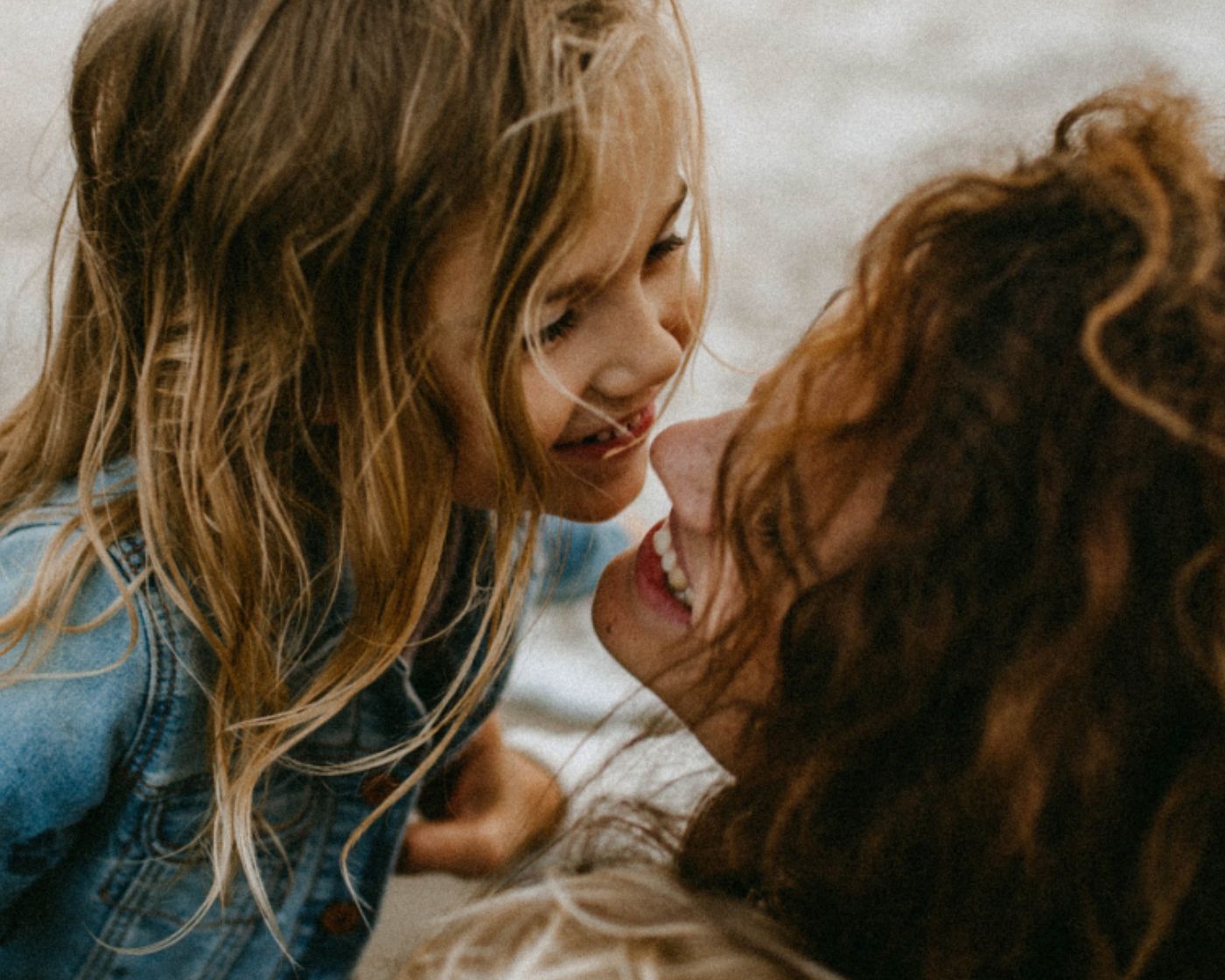 A mother and daughter sharing a close, joyful moment
