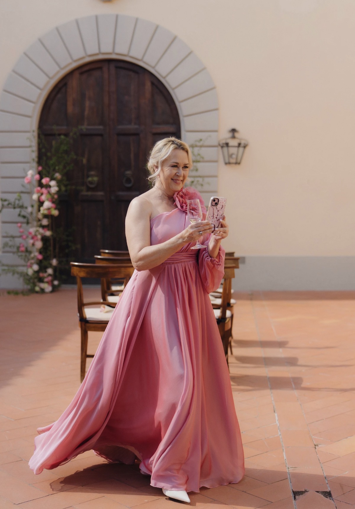 Amelia as mother of the bride, wine glass in hand
