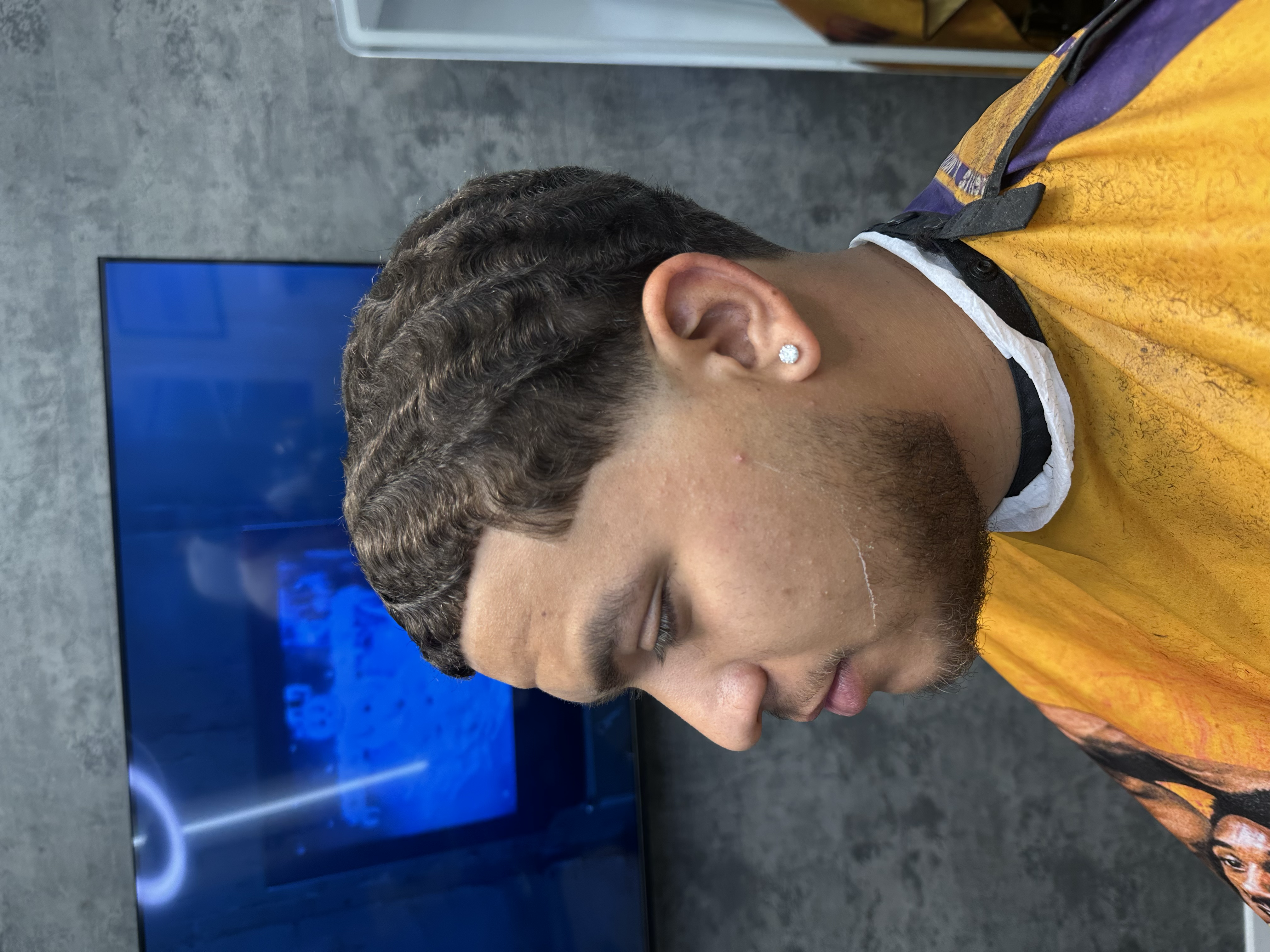 low fade haircut by barber Alexis Rivera at Blacklaces in West Hollywood, Los Angeles