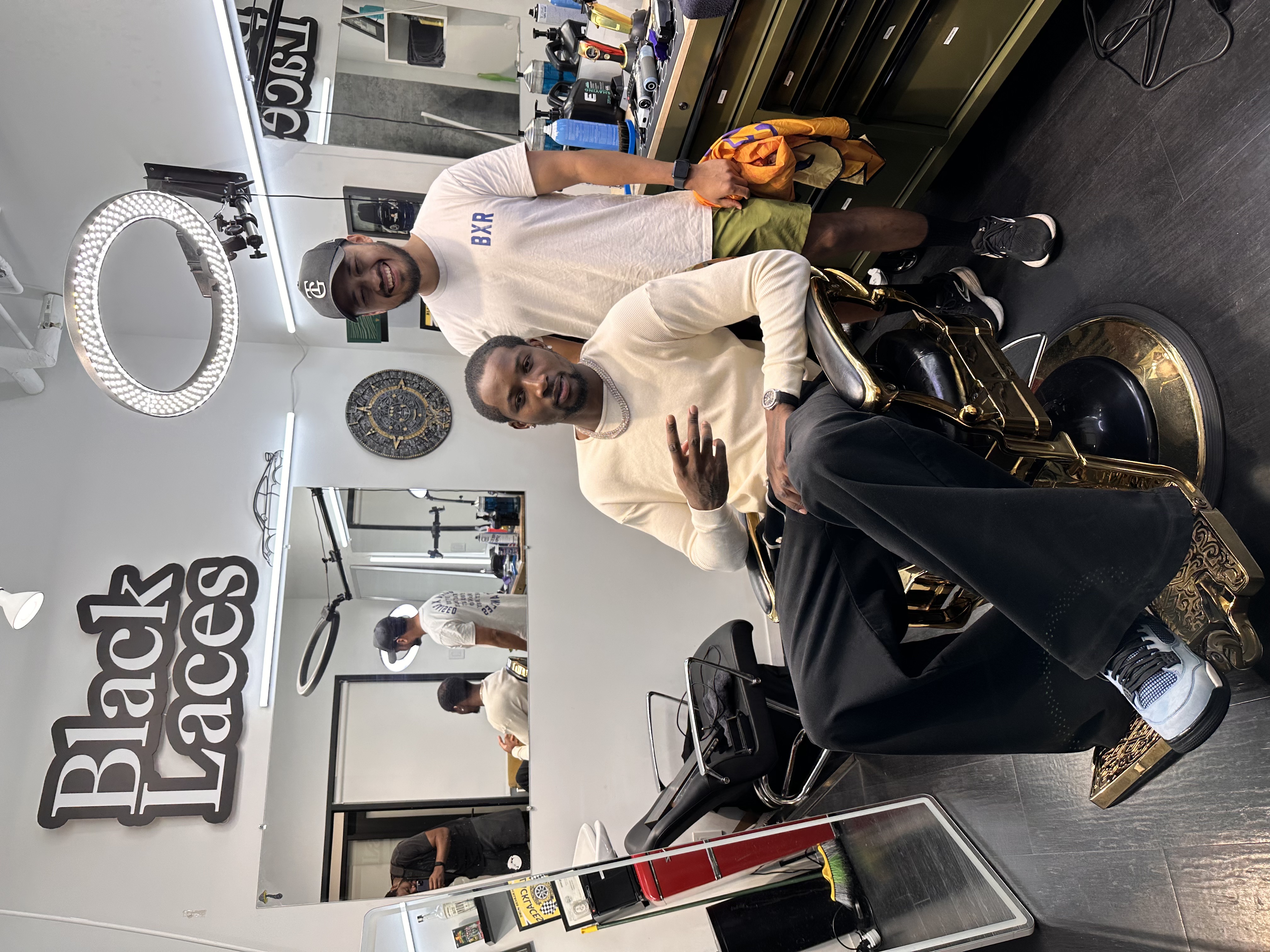 Jonathan Kuminga of the Minnesota Timberwolves in the chair at Blacklaces barber studio