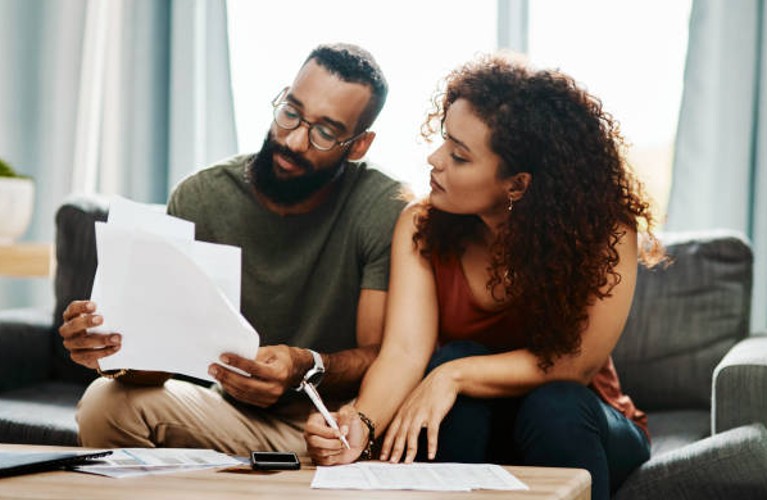 Couple reviewing HVAC financing options and proposal document Couple reviewing HVAC financing options and proposal document