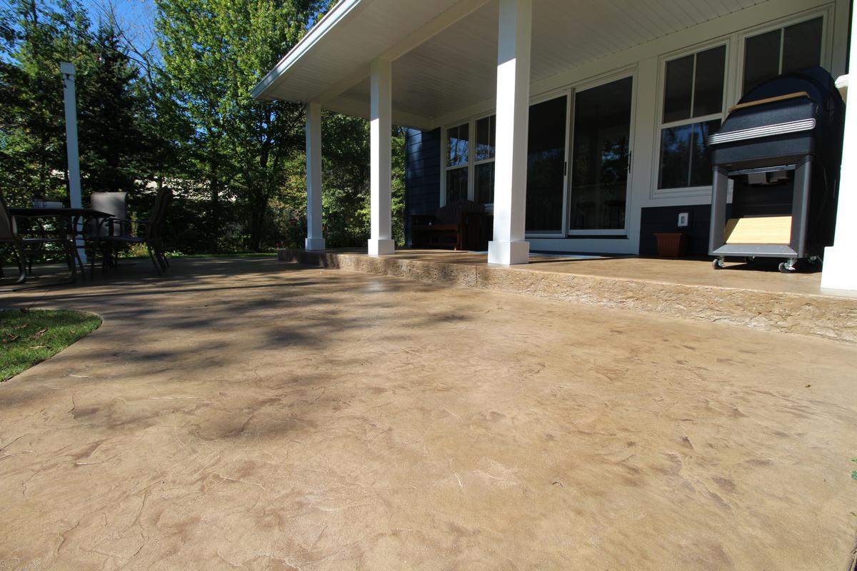 Stamped concrete patio under covered porch in Rib Mountain, WI