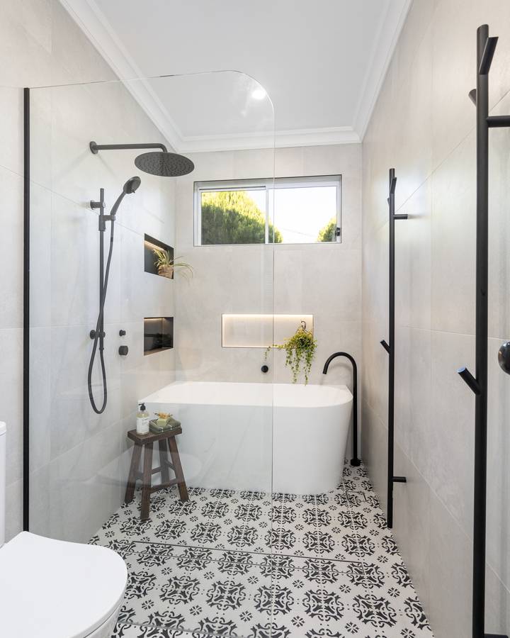 Main bathroom: Freestanding bath, walk-in shower, patterned floor tiles