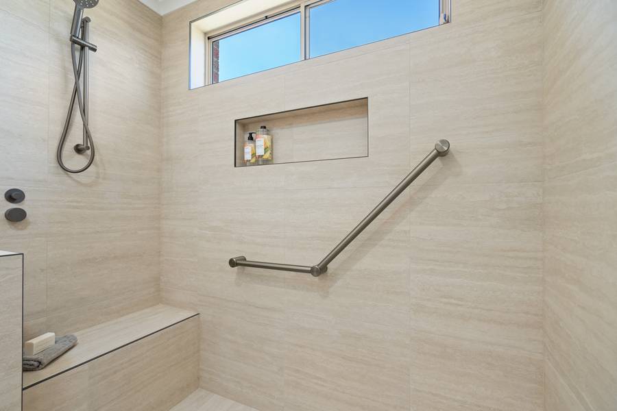 Walk-in shower with built-in seat and niche