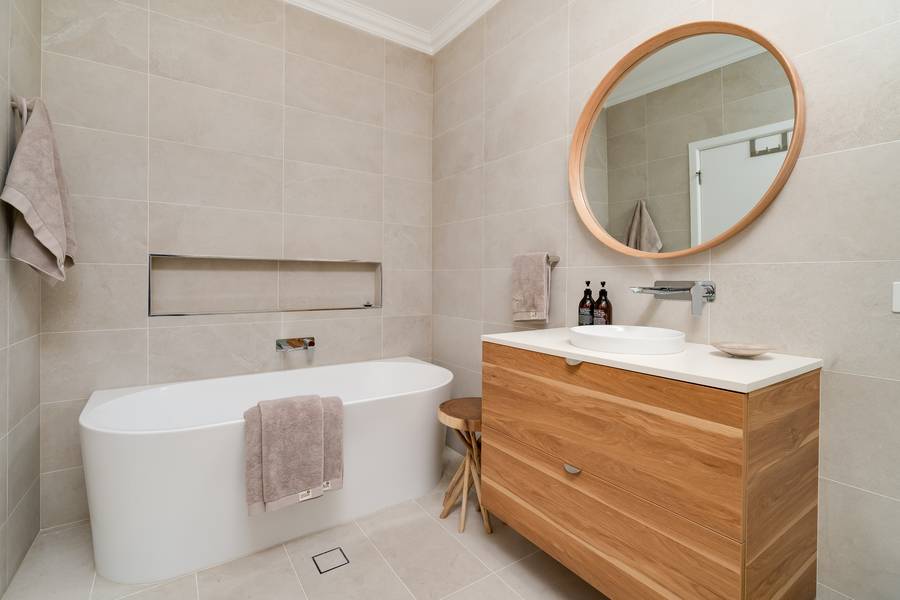 Bathroom with freestanding bath and timber vanity