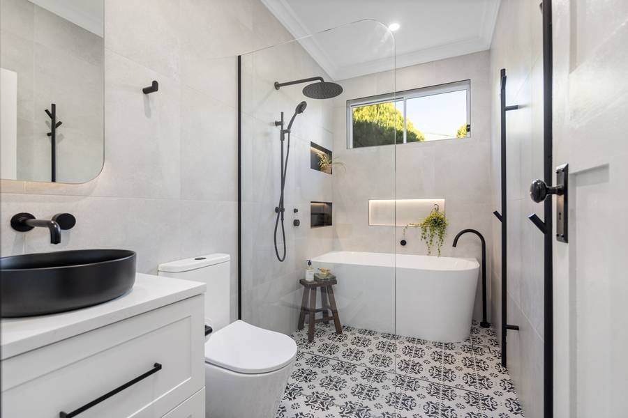 Main bathroom with freestanding bath and patterned floor