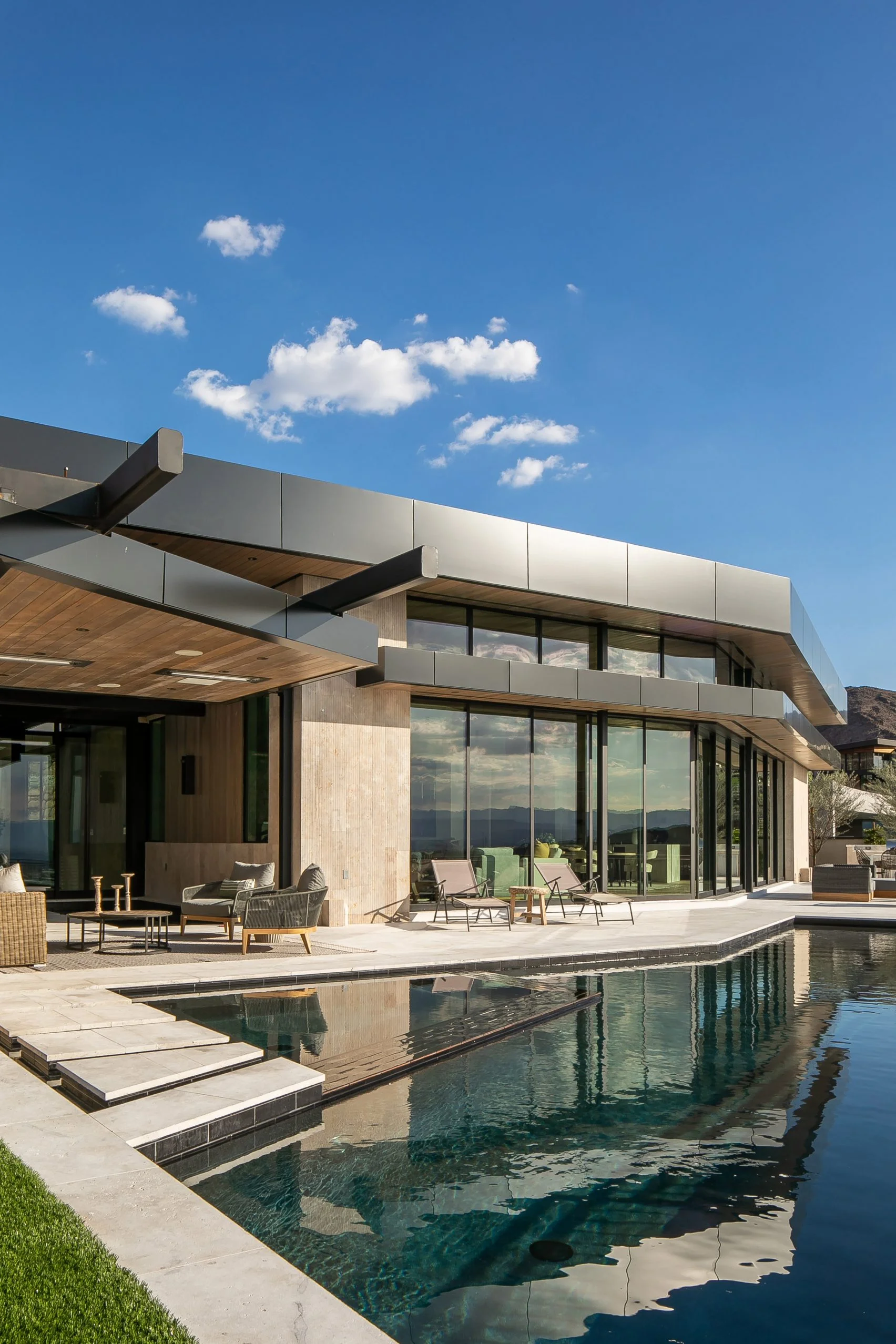 Window design inspiration: large dark frames and a seamless view to a desert courtyard