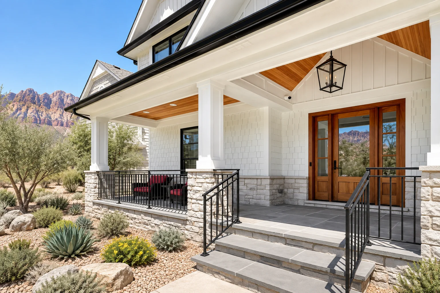 Nevada design concept: white shake siding, substantial columns, wood soffits, and stone at a desert entry