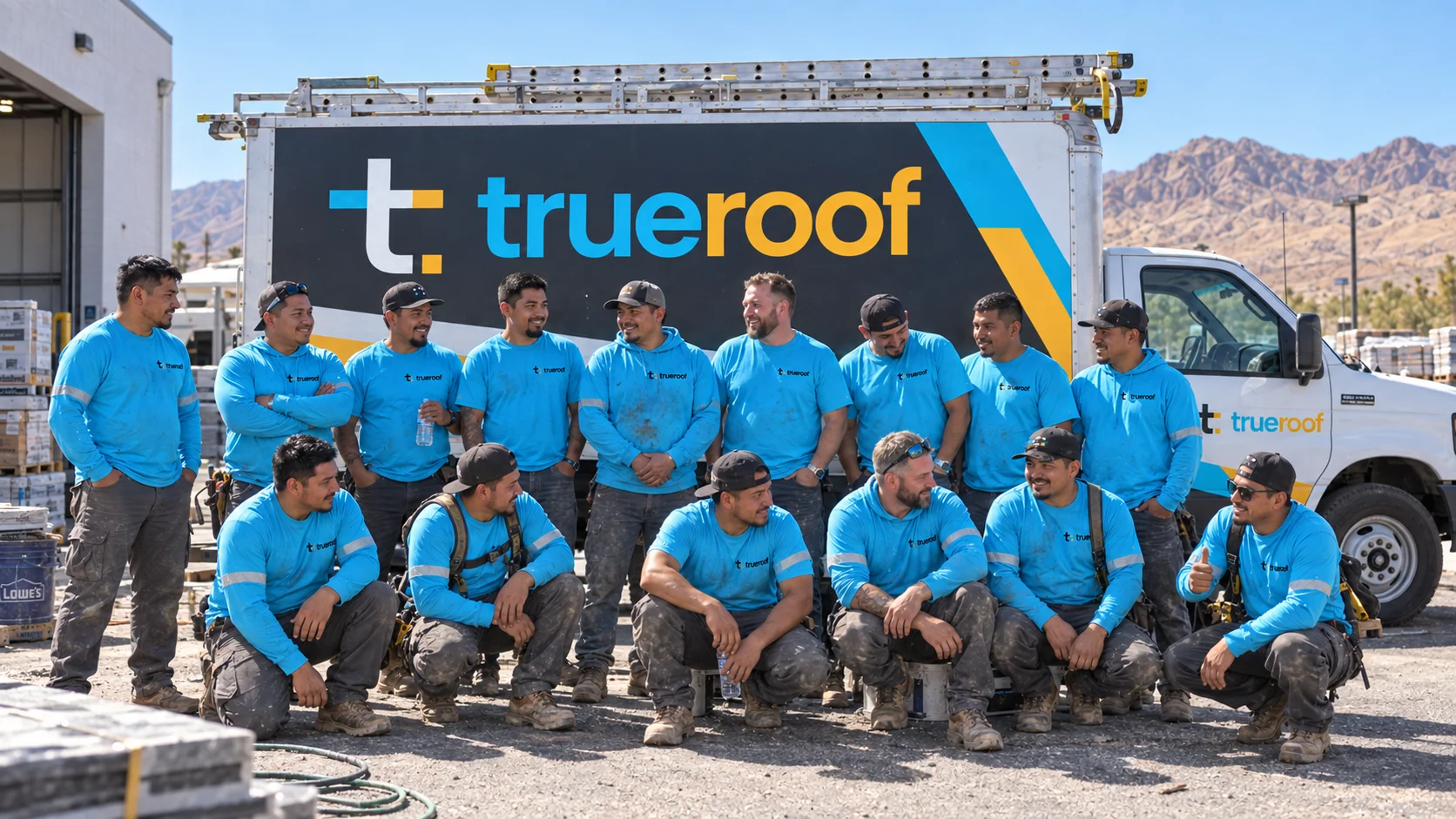 TrueRoof wrap and uniform concept: a 16-person crew in cyan workwear beside a branded box truck in Nevada