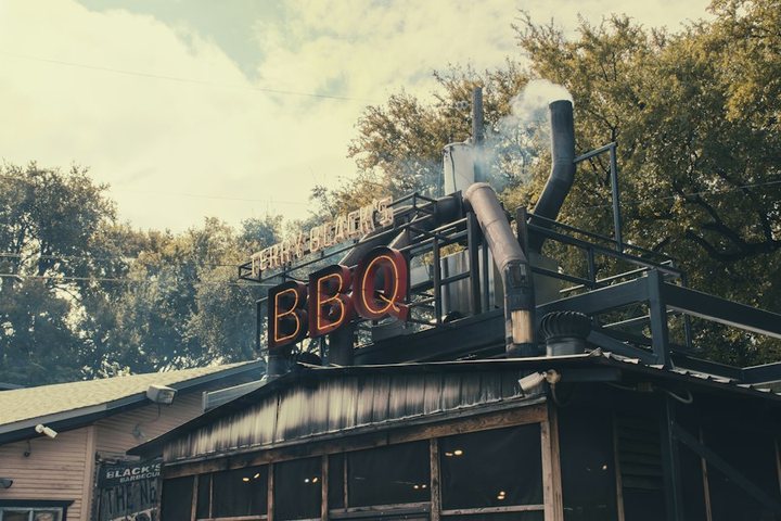 Perry’s Smokehouse, a barbecue restaurant with smoke rising from the pit